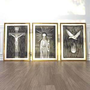 May include: Three black and white framed prints with gold frames. The prints depict a stylized image of Jesus on the cross, Jesus with a halo and a raised hand, and a dove with a flame.