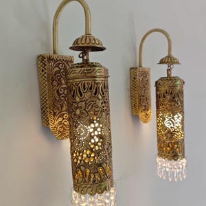 Elegant brass wall sconce with crystal prism accents luxury interior lighting