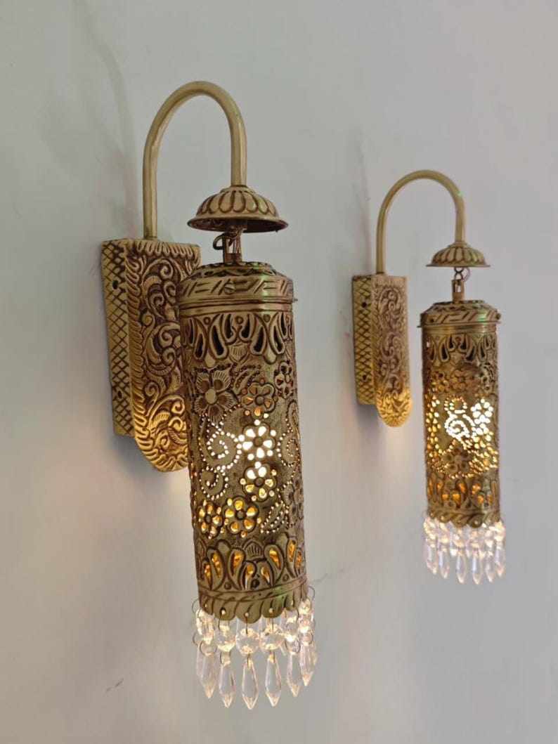 Elegant brass wall sconce with crystal prism accents luxury interior lighting