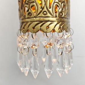 Handcrafted brass cylinder wall sconce with crystal droplets and ornate carving