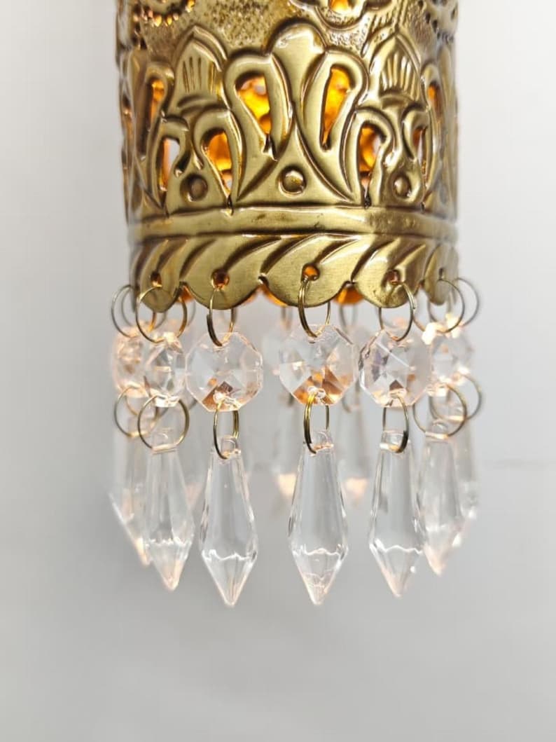 Handcrafted brass cylinder wall sconce with crystal droplets and ornate carving