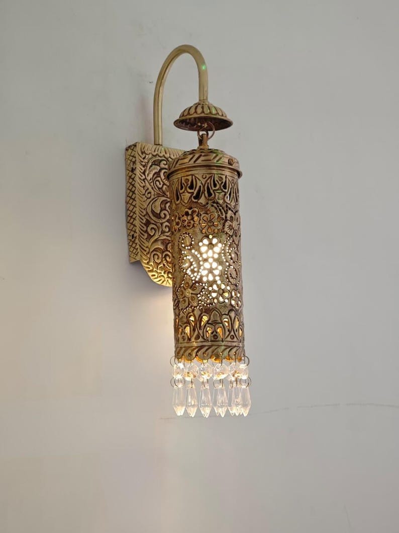 Traditional carved brass wall lantern with warm ambient glow effect