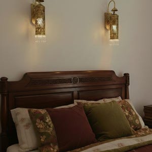Vintage brass wall light fixture with hand pierced floral design and warm glow

Luxury boho brass wall sconce UL listed E17 crystal hanging accent light

Moroccan style brass lantern wall mount lighting for bedroom hallway decor

Handcrafted brass cylinder wall sconce with crystal droplets and ornate carving

Antique brass wall lamp with pierced metal shade casting decorative shadows