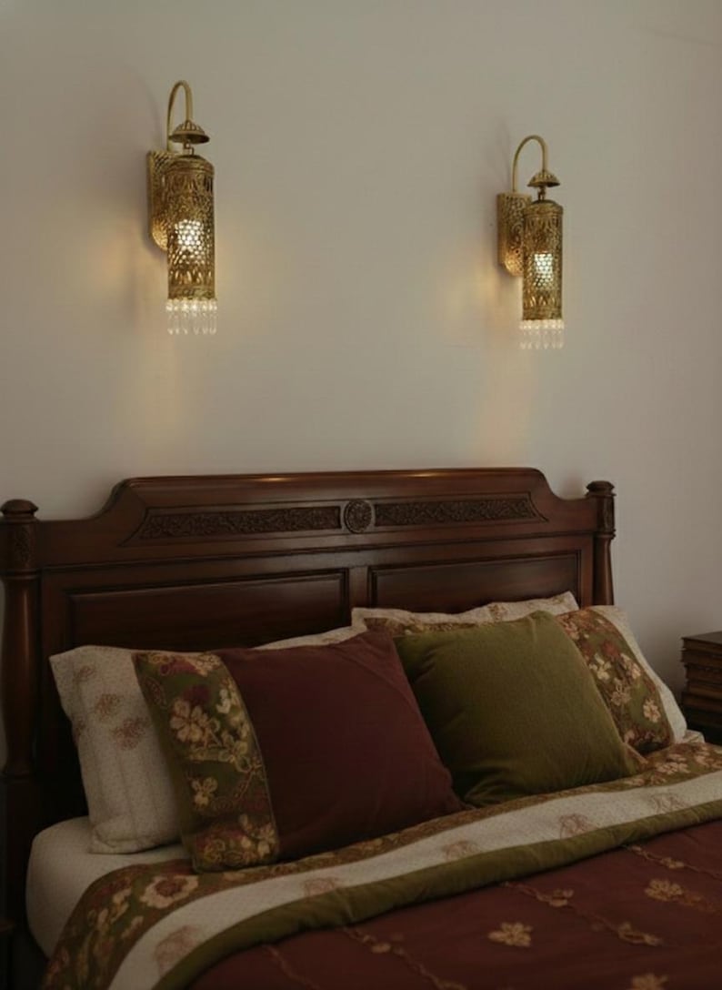 Vintage brass wall light fixture with hand pierced floral design and warm glow

Luxury boho brass wall sconce UL listed E17 crystal hanging accent light

Moroccan style brass lantern wall mount lighting for bedroom hallway decor

Handcrafted brass cylinder wall sconce with crystal droplets and ornate carving

Antique brass wall lamp with pierced metal shade casting decorative shadows