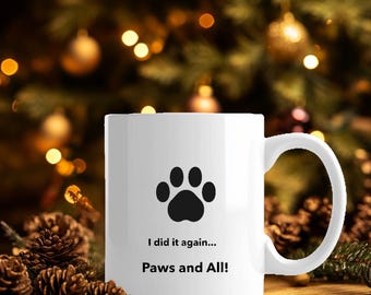 Könnte beinhalten: Eine weiße Keramik-Kaffeetasse mit einem schwarzen Pfotenabdruck und dem Text "I did it again... Paws and All!"