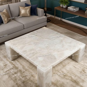 May include: A square, white quartz coffee table with a veined pattern. The table has a solid, block-like base and a smooth, polished surface. The table is approximately 122 cm square and 41 cm high.