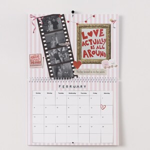 May include: A Valentine's Day themed calendar with a pink and white striped background. It features a film strip with black and white photos, a framed message that reads "LOVE ACTUALLY IS ALL AROUND", and the month of February.