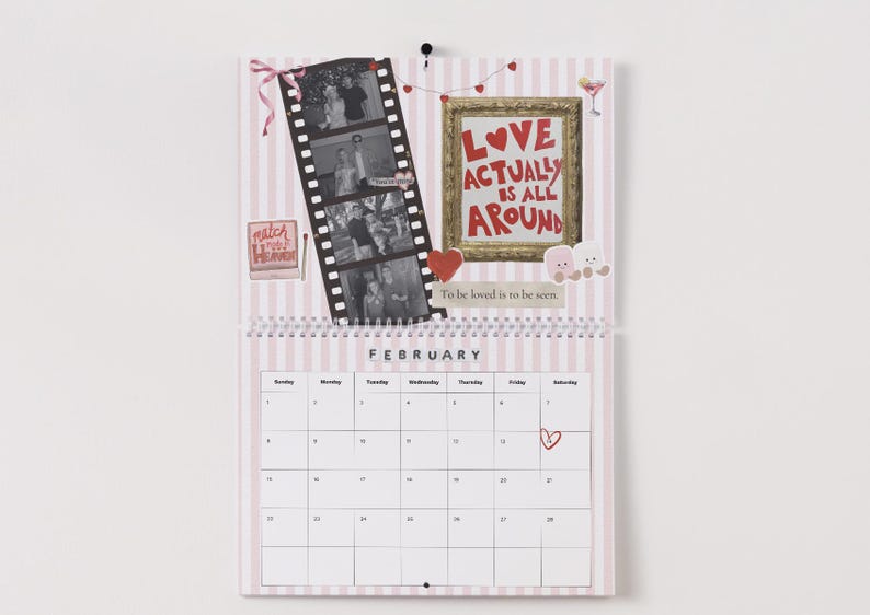 May include: A Valentine's Day themed calendar with a pink and white striped background. It features a film strip with black and white photos, a framed message that reads "LOVE ACTUALLY IS ALL AROUND", and the month of February.