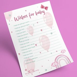 May include: A baby shower game card with the text "Wishes for baby" in pink script. The card features pink balloons, hearts, a rainbow, and the words "with love." The card includes prompts for guests to write wishes for the baby.