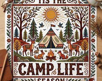 May include: A square art print with a camping theme. The print features a tent, campfire, deer, rabbits, and foxes, with the words "'Tis the Camp Life Season" in a decorative font. The artwork is framed with a border of leaves and flowers.