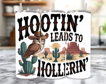 May include: White tumbler with a brown owl wearing a cowboy hat and the text "Hootin' Leads to Hollerin'" with a desert landscape in the background.