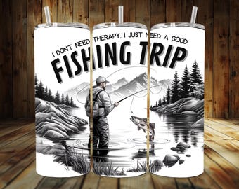 May include: A white tumbler with a black and white illustration of a person fishing. The text on the tumbler reads "I don't need therapy, I just need a good fishing trip."
