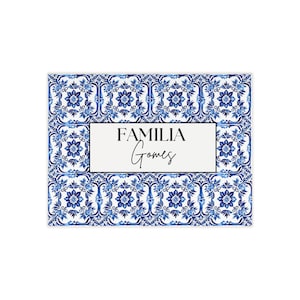 May include: Rectangular decorative tile with a blue and white floral pattern. The centre features a white rectangle with the words "FAMILIA Gomes" in black script.