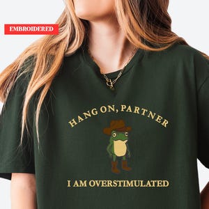 Hold On Partner I’m Overstimulated Embroidered Sweatshirt, Cowboy Frog Unhinged Shirt, Weirdcore Gen Z Crewneck sweatshirt, funny jumper,top