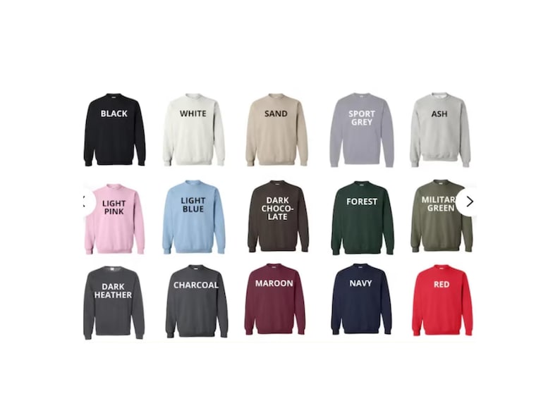 May include: A collection of crewneck sweatshirts in various colors, including black, white, sand, sport grey, ash, light pink, light blue, dark chocolate, forest, military green, dark heather, charcoal, maroon, navy, and red. Each sweatshirt has the color name printed on it.