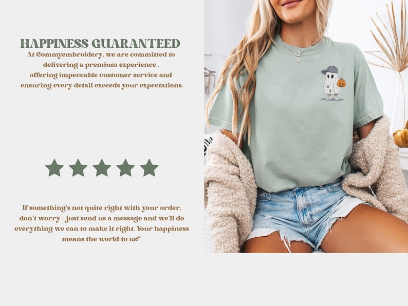 May include: A light green t-shirt featuring an embroidered ghost wearing a baseball cap and holding a pumpkin. The shirt has the text "HAPPINESS GUARANTEED" and a customer satisfaction message.