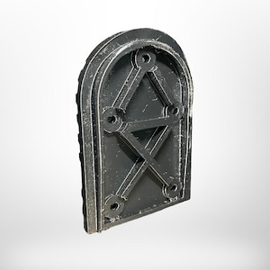 May include: A black, arched, 3D-printed object with a geometric design. The object features a series of holes and an internal structure of intersecting lines. The edges are textured, and the overall shape is reminiscent of a small door or window.