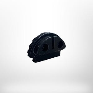 May include: A black, geometric object with a rounded top and two circular holes. The object has a textured, ridged edge on one side and a vertical slot. The item is set against a white background.