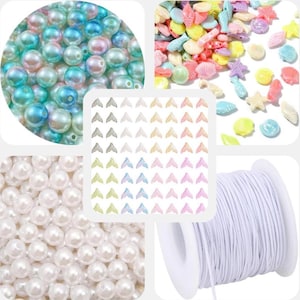 May include: A collection of craft supplies including iridescent beads, white pearl beads, colorful seashell and starfish charms, mermaid tail charms, and a spool of white elastic cord. Ideal for jewelry making and crafting projects.