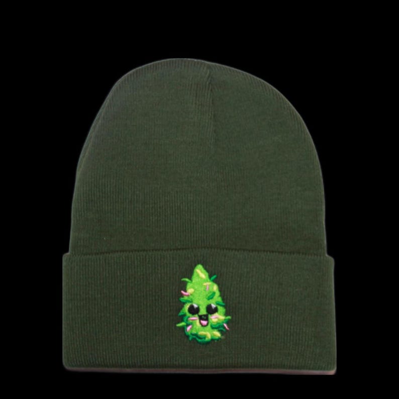 May include: A dark green beanie with a green cartoon marijuana leaf with a smiling face embroidered on the front.