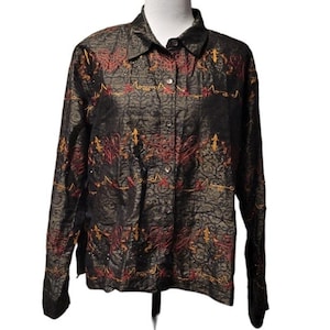 May include: A black long-sleeved button-up shirt with a gold and red embroidered pattern. The shirt has a collared neckline and a button-up front.