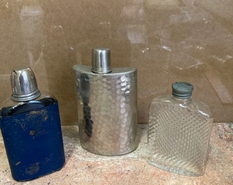 Lot of three vintage flasks from the 1940s and 50s. Very rare collection, metal and glass.