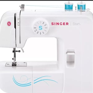 May include: A white Singer Start sewing machine with blue thread spools. The machine has a circular dial with stitch settings and the Singer logo. The machine has a decorative blue wave design on the front.