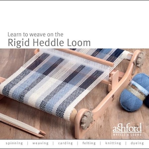 May include: A wooden rigid heddle loom with blue and white woven fabric. The text "Learn to weave on the Rigid Heddle Loom" is at the top. A ball of blue yarn is on the right. The Ashford Wheels & Looms logo is at the bottom.