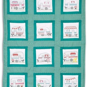 May include: A teal blue fabric with white embroidered camper vans in different designs. Each camper van is surrounded by a white square with a teal blue border. The fabric has a white background with a small repeating pattern.