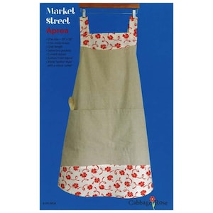 May include: A beige linen apron with a red floral print trim. The apron has a large pocket and two cross straps. The text "Markel Street Apron" is printed on the top left corner of the image.