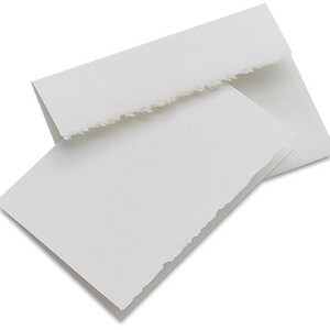 May include: Two white, blank, folded note cards with deckled edges. The cards are made of textured paper.