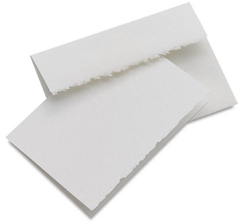 May include: Two white, blank, folded note cards with deckled edges. The cards are made of textured paper.