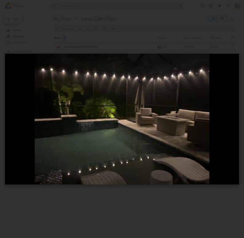 May include: Outdoor nighttime scene featuring a swimming pool with string lights overhead. The pool area includes lounge furniture, a table, and a covered patio. The lighting creates a relaxing ambiance for an evening gathering.