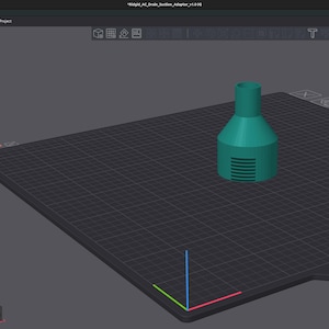 May include: A teal 3D-printed object, possibly a nozzle or adapter, is positioned on a black grid surface. The object features a cylindrical top and a wider, ridged base. The image is a screenshot of 3D modelling or printing software.