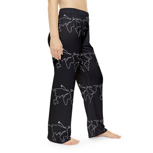 May include: Black pajama pants with a white outline of the world map and airplanes on the print.