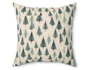 May include: A beige throw pillow with a repeating pattern of dark green stylised pine trees and white snowflakes.