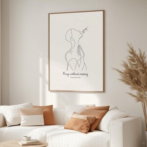 May include: A minimalist line art print of a person praying with the text "Pray without ceasing. 1 Thessalonians 5:17" below the image.