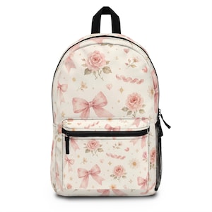 May include: A cream-colored backpack featuring a repeating pattern of soft pink roses, light pink bows, and small gold star accents. The bag includes a black top handle, black zippers, and a black mesh side pocket for storage and organization.