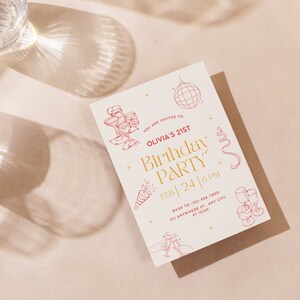 May include: A white invitation card with gold and red text. The text reads "You are invited to Olivia's 21st Birthday Party Feb 24 | 6 PM RSVP to 123-456-7890 123 Anywhere St., Any City, ST 12345". The card is decorated with red illustrations of champagne glasses, a disco ball, and confetti.