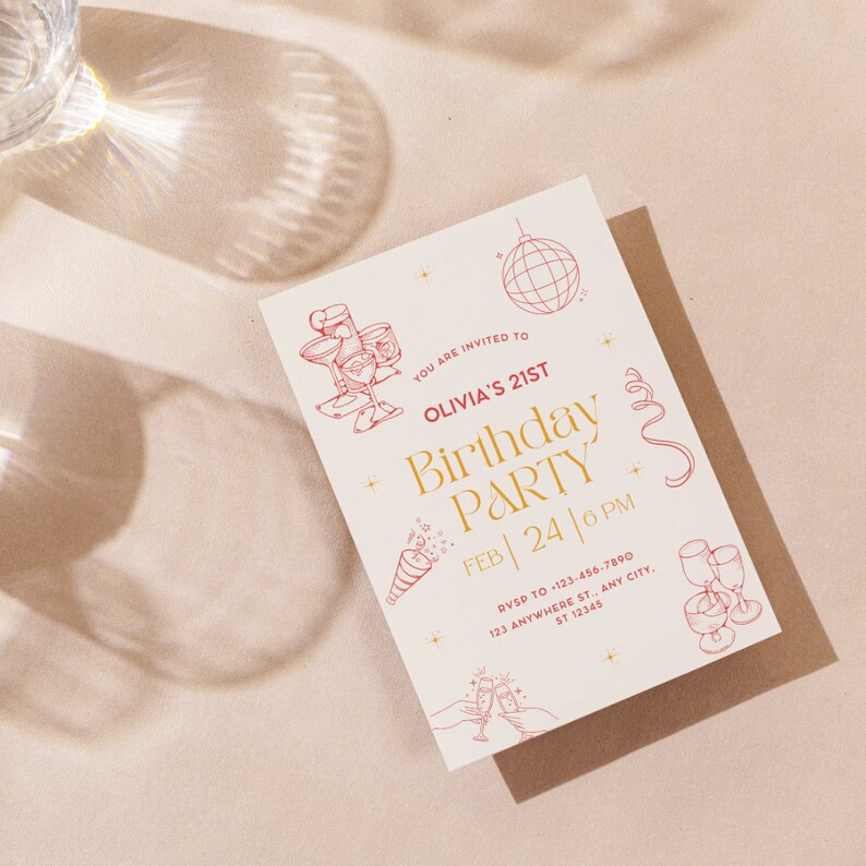 May include: A white invitation card with gold and red text. The text reads "You are invited to Olivia's 21st Birthday Party Feb 24 | 6 PM RSVP to 123-456-7890 123 Anywhere St., Any City, ST 12345". The card is decorated with red illustrations of champagne glasses, a disco ball, and confetti.