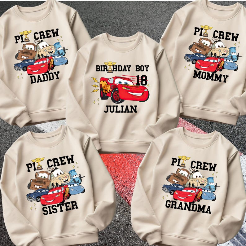 May include: A white ceramic mug with a black handle and the text "But First, Coffee" in a black, handwritten-style font. The mug is on a white surface.