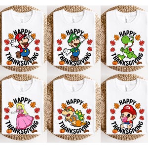 May include: Six white t-shirts featuring various Nintendo characters including Mario, Luigi, Yoshi, Princess Peach, Bowser, and Baby Mario. Each shirt displays a circular graphic with autumn leaves, a pumpkin, and the text Happy Thanksgiving.