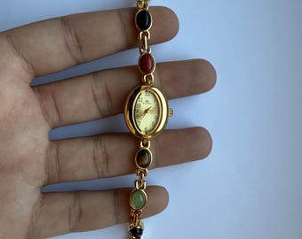 dainty gold and multicolour stones watch