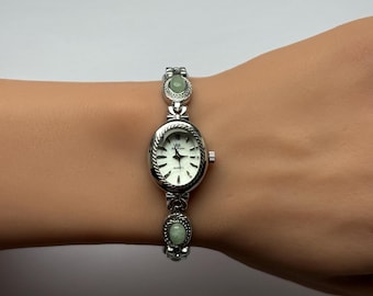 silver green stones and ribbons watch