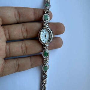 silver green stones and ribbons watch