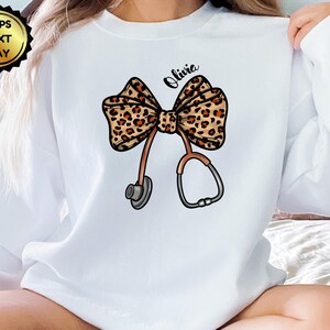 Personalize Coquette Nurse Sweatshirt, T-Shirt or Sweatshirt, Nurse Graduation, Healthcare, Leopard Print Stethoscope Bow, Gift for Nurse