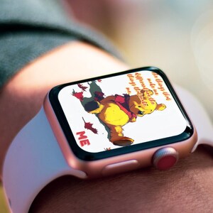 May include: A rose gold Apple Watch with a white band displays a Winnie the Pooh illustration and the text "The only way to do great work is to love what you do."  "Make me different, make me things that make me..."