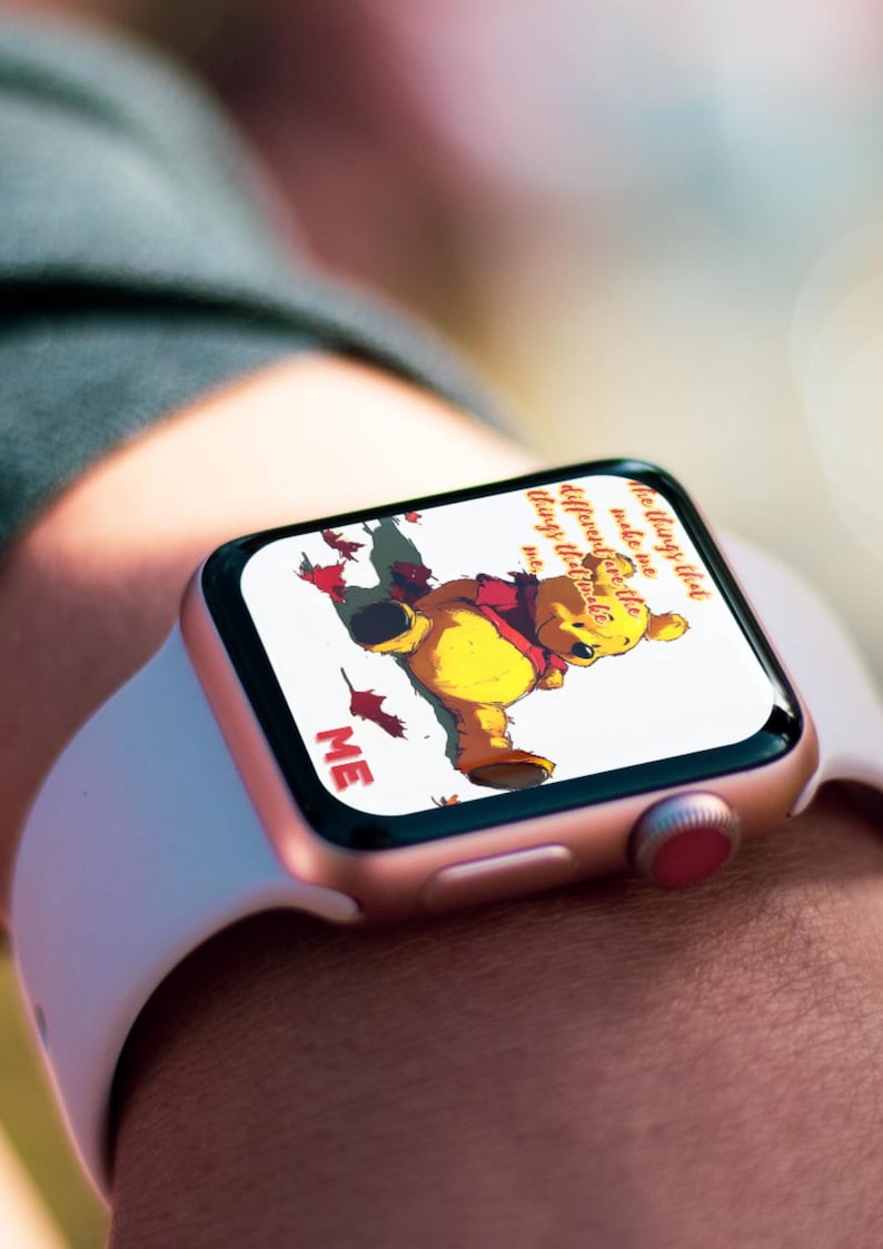 May include: A rose gold Apple Watch with a white band displays a Winnie the Pooh illustration and the text "The only way to do great work is to love what you do."  "Make me different, make me things that make me..."