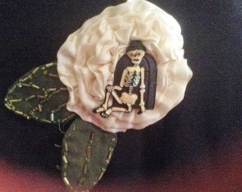 Cute Skeleton Pin on ivory silk flower