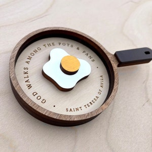 May include: A handcrafted wooden 'Welcome' sign in a playful font. It has a distressed white backdrop and a dark brown frame, with a small heart detail. Suitable for indoor or outdoor display.